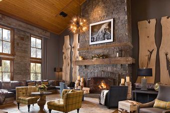Cozy lounge with stone fireplace at Teton Mountain Lodge Alpine Studio.