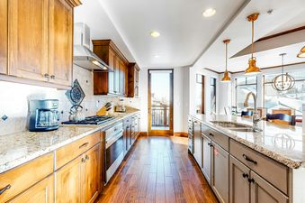 The kitchen at Canyons Village Centric Luxury 4 BR Suite 423 ABC features granite countertops and stainless steel appliances.