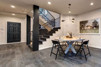 Twin Pines Home features a modern and sleek dining area with a large table and black chairs.