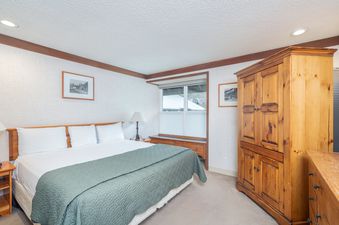 The bedroom in Mountainside Inn 413 features a plush king-sized bed and ample storage.